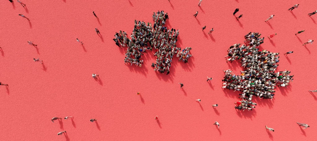 A group of people standing on a pink surface.