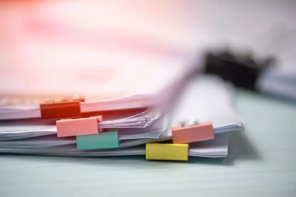 A stack of colorful paper clips on a table, ready to wrangle.