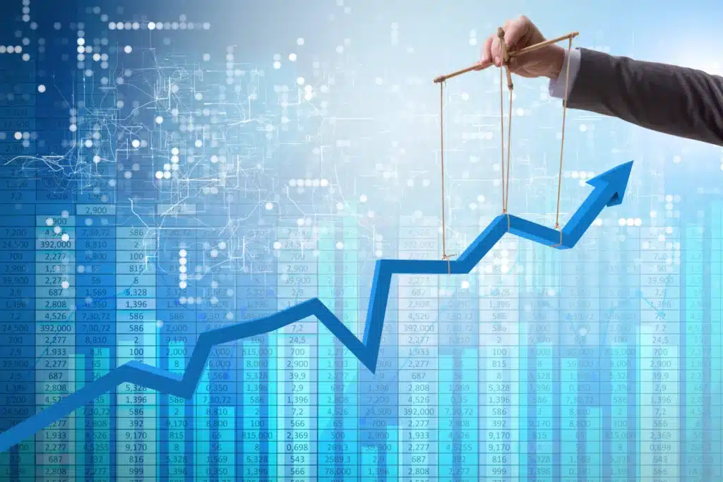A businessman is holding up an upward arrow on a background of a graph, symbolizing the observability of success.