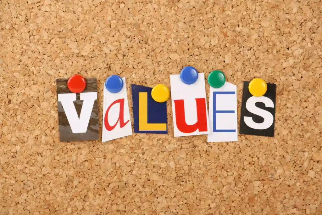 The word values is written on a cork board.