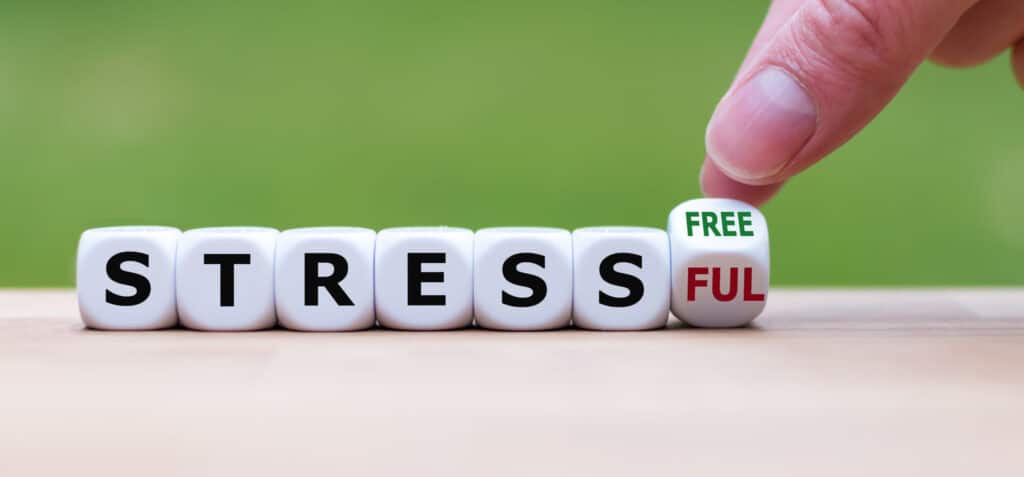 A hand is guiding towards the word "free stress".