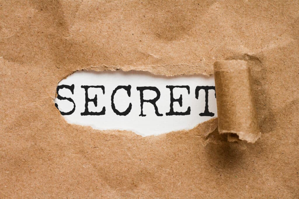 A brown paper with the word secret written on it, aiding in reducing team stress.