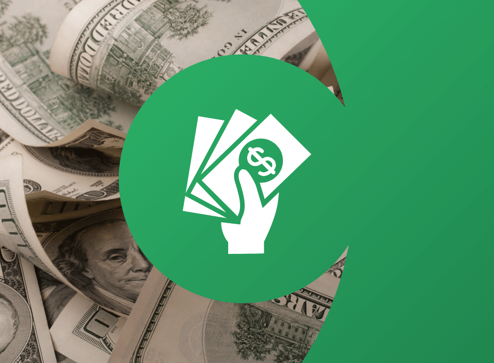 A hand is holding an expensive stack of money in front of a green background.
