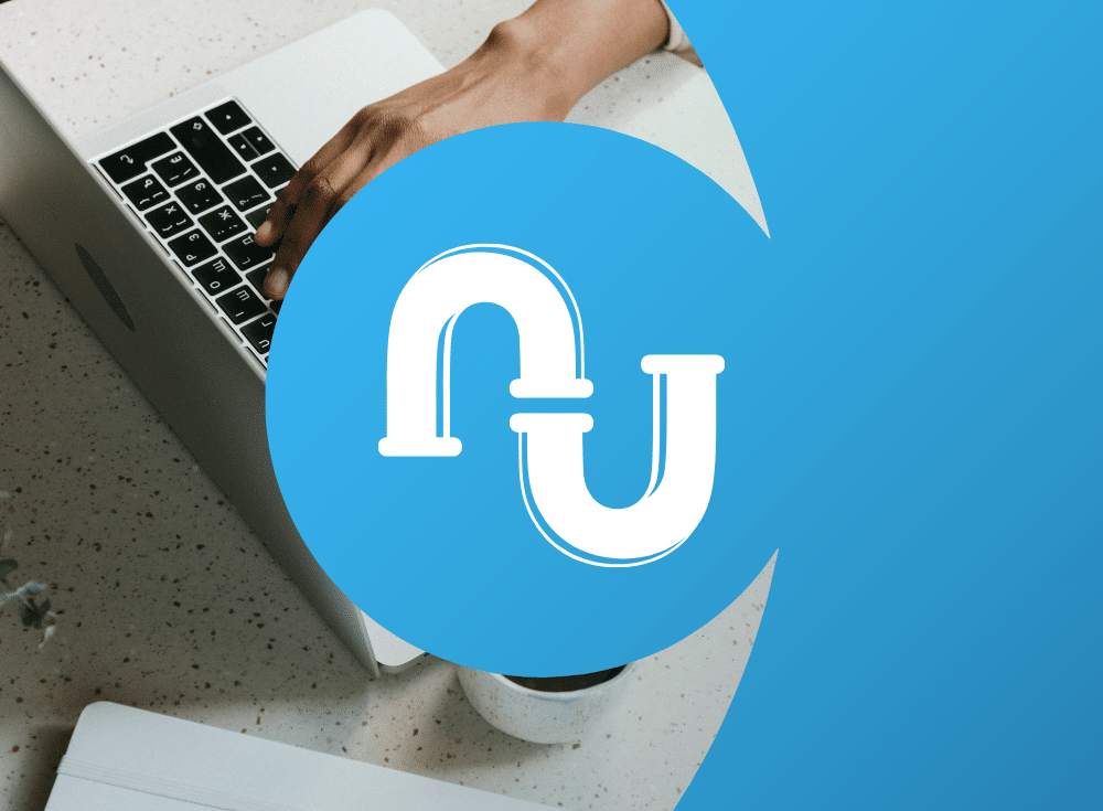 A person types on a laptop with a blue logo displaying a stylized letter "U" overlapping a circular background, reading through a practical guide to reduce log data costs efficiently.