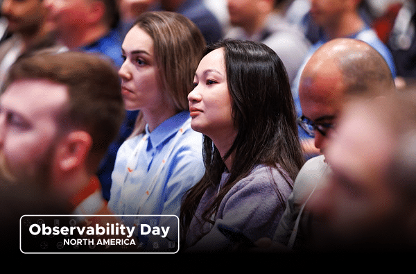 A diverse group of people sit attentively in an audience at Observability Day, part of KubeCon North America.